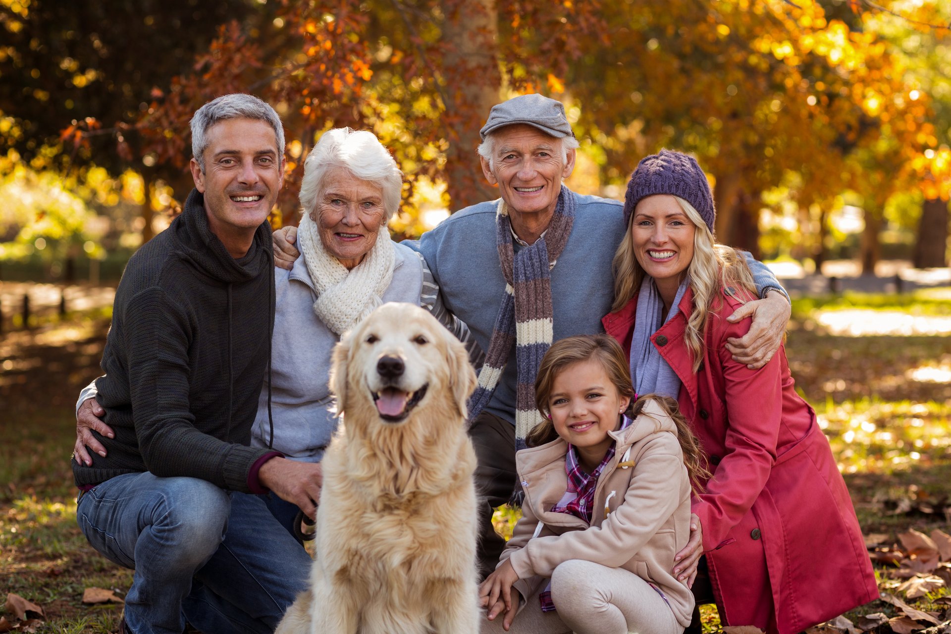 A happy multi-generational family with their dog